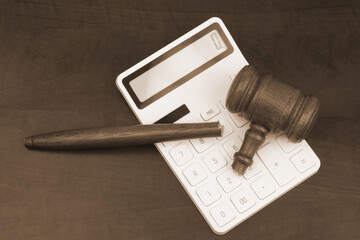 Broken gavel on calculator on table. Arbitrage court mistake concept.