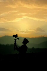 silhouette of a photographer at sunset