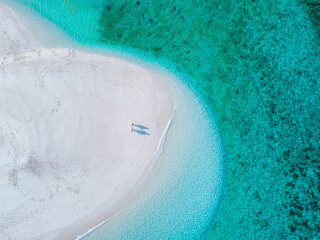men and women walking on a sandbar in the ocean of Koh lipe Southern Thailand during vacation