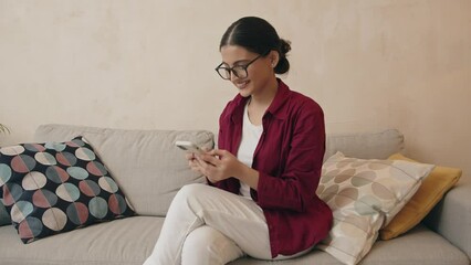 Smiling indian woman enjoying mobile phone communication