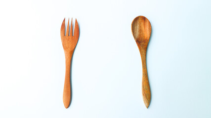 Wooden spoon and fork isolated on white background. Kitchen and cooking concept.