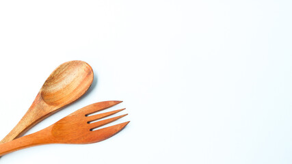 Wooden spoon and fork isolated on white background. Kitchen and cooking concept.