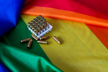 9mm cartridges or bullets over a gay pride flag