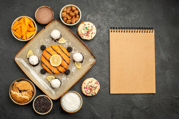 top view delicious little cake with coconut candies on a dark-grey background cake dessert biscuit pie cookie tea