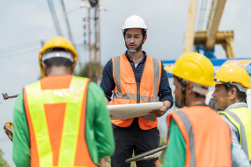 Male engineers are inspecting and controlling the work of the employees and the quality of the manufactured products to meet the standards In industrial factories producing precast prefabricated walls