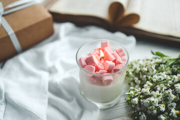 Burning candle, open book, gift box, holiday greeting card