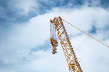 Modern yellow construction cranes above blue sky