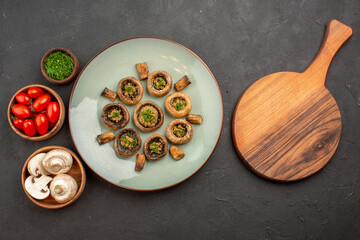 top view delicious mushrooms meal with fresh greens and tomatoes on the dark background dish dinner meal cooking mushroom