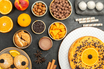 top view delicious pie with orange slices and cookies on a dark background tea biscuit fruit dessert pie cake