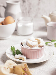 Indonesian Idul Fitri special offerings : Putri Salju or Snow White Cookies. Which is crescent-shaped and coated with powdered sugar covered like snow