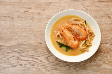 boiled river shrimp with herb in Thai spicy soup or tom yum kung on plate