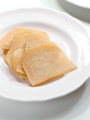Kerupuk Udang Mentah or Raw Shrimp Crackers in white plate