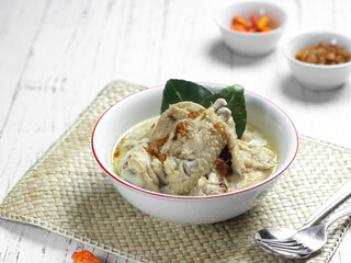 Opor ayam or chicken white curry is traditional Indonesian culinary food made from chicken cooked with coconut milk and spices, served to celebrate Eid al Fitr or Lebaran