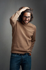 Naklejka premium Whats not to love about Mr Charming. Studio shot of a handsome young man posing against a gray background.