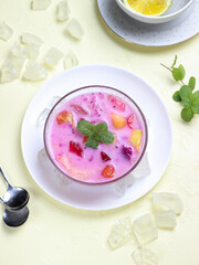 sop buah or fruit soup is indonesian fruit cocktail ice made from various diced fruits mixed with ice cubes, condensed milk and red syrup. popular food for breakfasting
