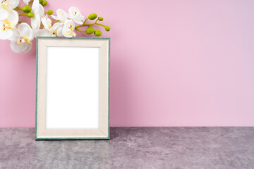 The Blank picture frame with white orchid flower on pink color background with copy space and clipping path for the inside.