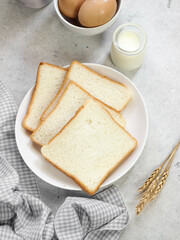 Sliced Toast Loaf White Bread (Shokupan or Roti Tawar) for Breakfast on Wooden Background, Served with Egg and Milk. Breakfast Concept Picture