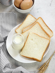 Sliced Toast Loaf White Bread (Shokupan or Roti Tawar) for Breakfast on Wooden Background, Served with Egg and Milk. Breakfast Concept Picture