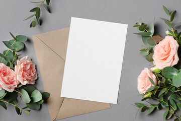 Wedding invitation card mockup with envelope, fresh eucalyptus and roses flowers