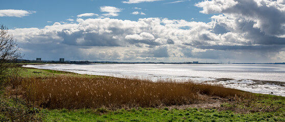View of the River Severn from Sharpness Docks, with Berkeley and Oldbury Magnox decommissioned Nuclear Power Station and the Severn Crossing bridges, United Kingdom