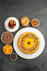 top view delicious sweet pie with orange slices and cup of tea on dark background cookies pie biscuit dessert tea cake