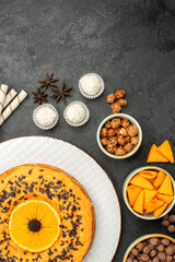 top view delicious sweet pie with orange slices on a dark-grey background dough fruit pie cake biscuit