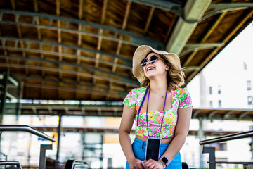 woman is looking at arriving train at a railway station