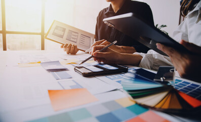 Close up ux developer and ui designer brainstorming about mobile app interface wireframe design on...