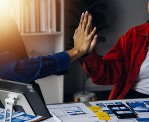 Close up ux developer and ui designer brainstorming about mobile app interface wireframe design on...