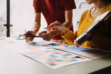 Close up ux developer and ui designer brainstorming about mobile app interface wireframe design on...