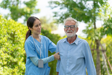Female home care nurse supports and assists senior man with all he daily needs