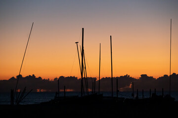 Wide angel views of a beach in the Riviera Romagnola area in Italy, with its red flaming colors and...