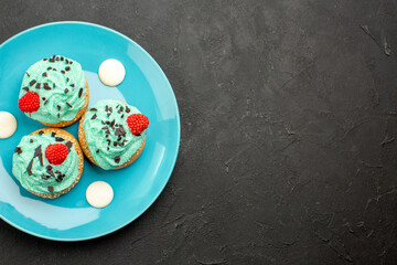 top view little creamy cakes delicious sweets for tea inside plate on dark desk cream cake biscuit dessert tea color