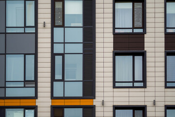 Windows on ventilated facade of typical modern residential building. Fragment of new elite residential building or commercial complex
