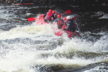Red raft boat during whitewater rafting extreme water sports on water rapids, group of sportsmen in...