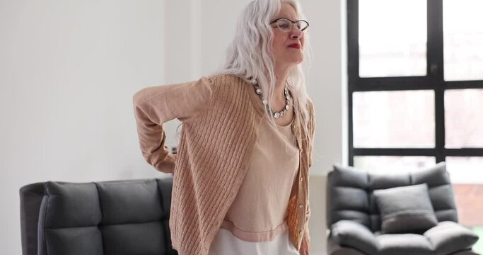 Old woman back pain at home and health problem concept. Back pain in elderly