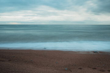 Long exposure of a beautiful empty coastline on a cloudy day