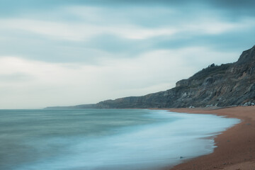 Long exposure of a beautiful empty coastline on a cloudy day