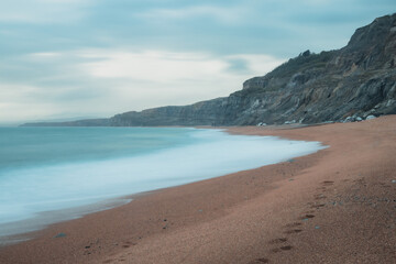 Long exposure of a beautiful empty coastline on a cloudy day