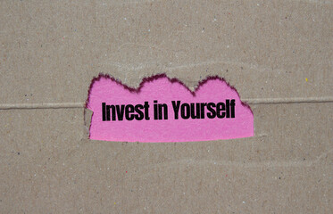 Invest in Yourself symbol. Torn paper background with Invest in Yourself text on it.