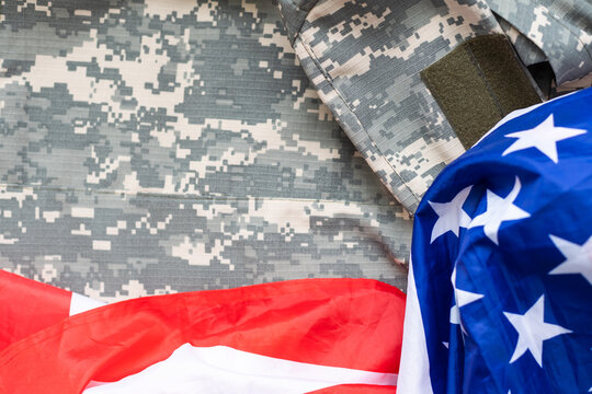 United States flag with camouflage military uniform for Independence, Veterans, labor, presidents or Memorial Day holiday concept.
