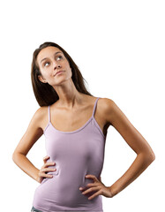 Emotional portrait of young woman isolated on neutral background. Looks up right, arms akimbo, hands on waist, hips tight. Slight smile, inventive. Long brown hair, slim, pink tank top. Thought and id
