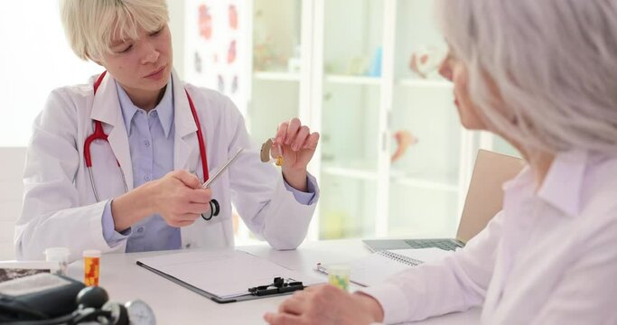 Audioprosthetist recommends hearing aids to elderly patient. Best solution for hearing concept