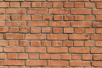 Obraz premium Brick wall. Brickwork from an old brick in a rustic style. Structure and pattern of the destroyed stone wall. Copy space