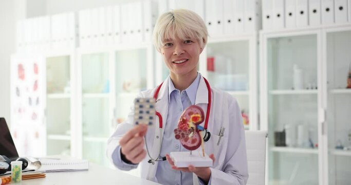 Doctor is holding medical pills and kidney anatomy. Concept of healthcare and early treatment of kidney disease