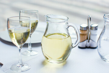 Jug of white wine with two glasses