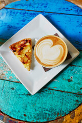 Coffee and apple pie on colorful green and blue cafe table