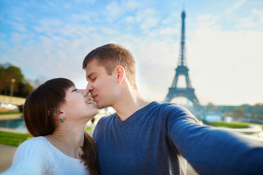 Tourists taking selfie near the Eiffel tower