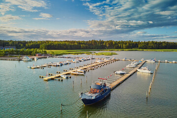 Scenic aerial view of colorful boats near wooden berth