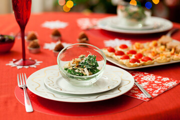 Decorated Christmas dining table with delicious salad (spinach, pear, blue cheese and pine tree nuts)
